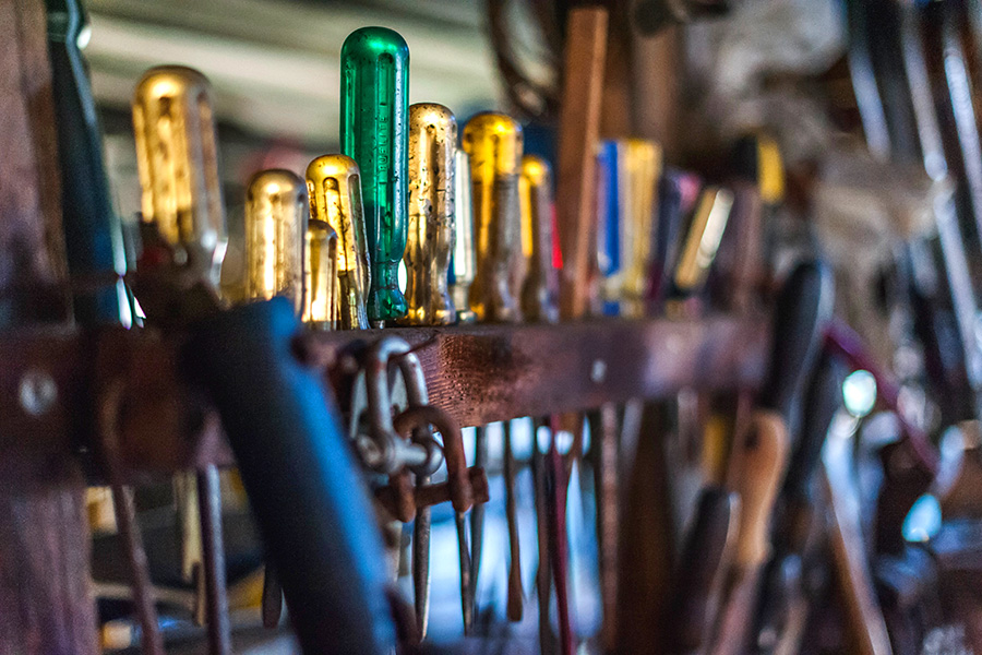 Tools and screwdrivers organized above a workbench