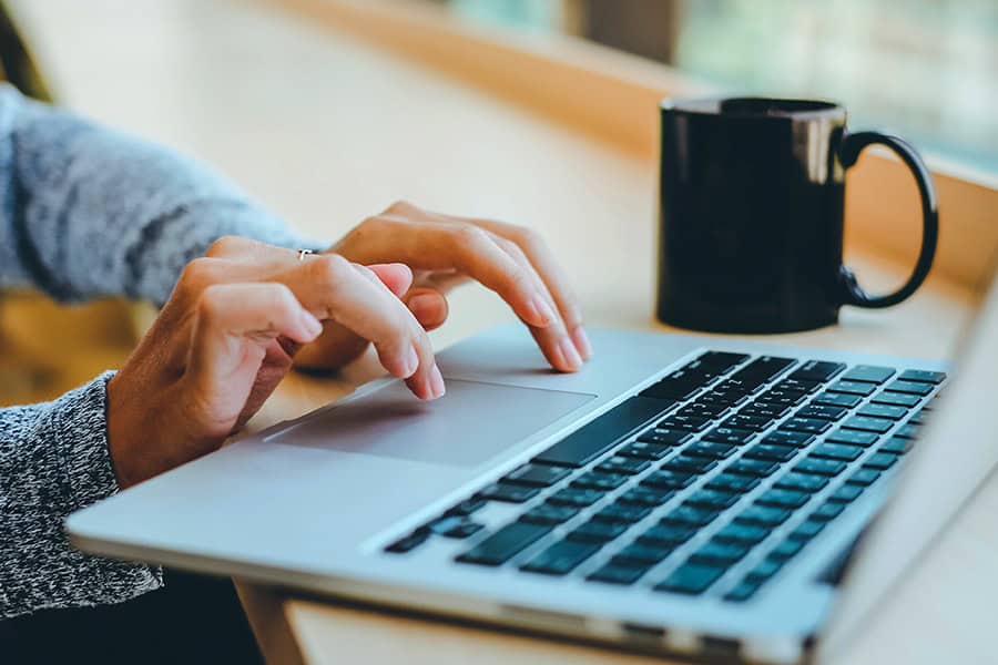 A woman working on a laptop to update WordPress