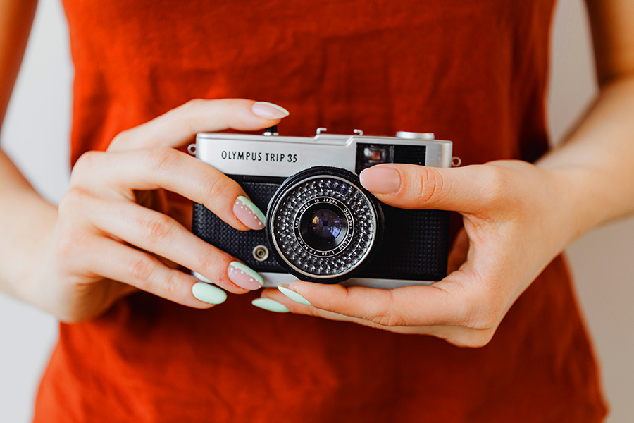 A photographer holding a camera while shooting stock photos to sell or make available for free