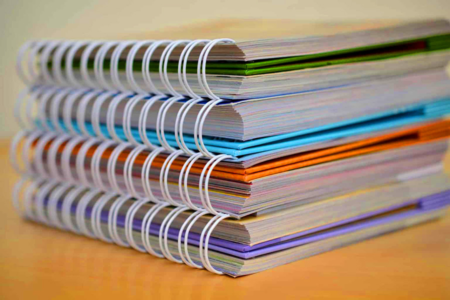 Stack of four spiral bound notebooks