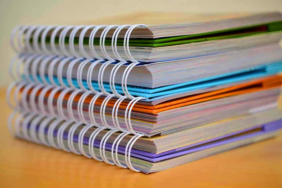 Stack of four spiral bound notebooks