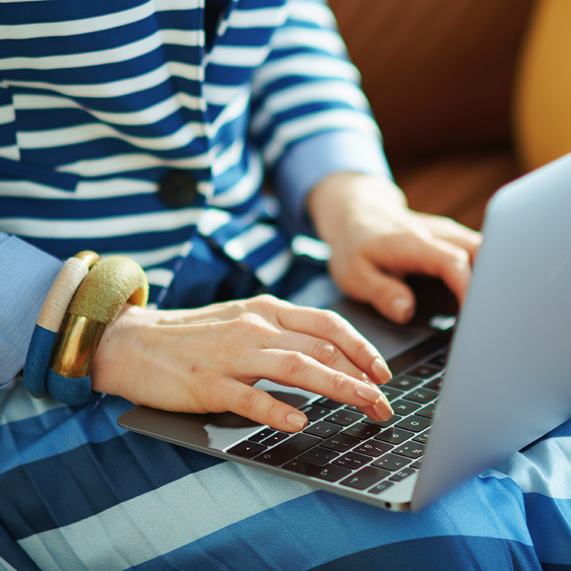 A woman blogging for business on a laptop