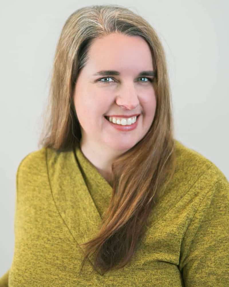 Leanne Mitton smiling and wearing a green sweater