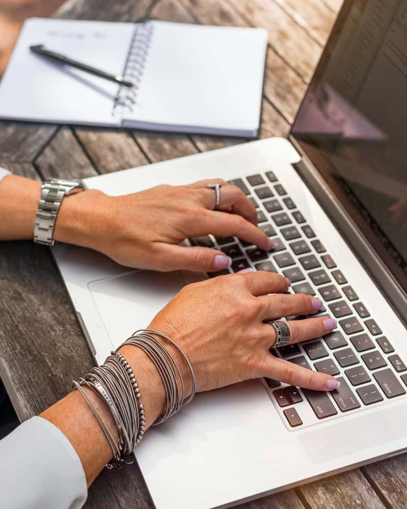 A woman writing a blog post so she can use content marketing to get more people to her website and get new clients