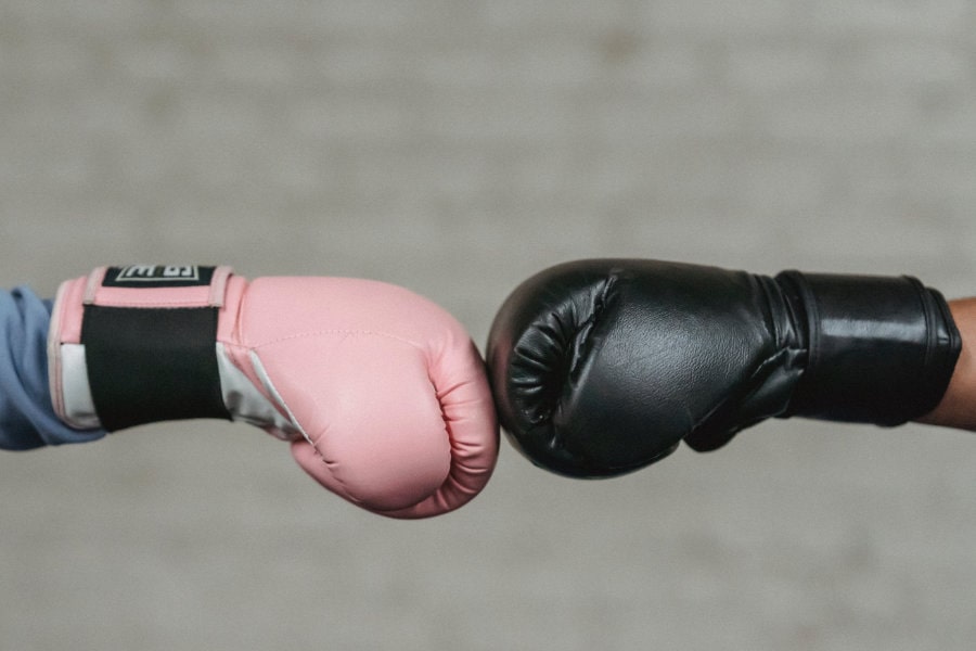 Two boxing gloves resting against each other