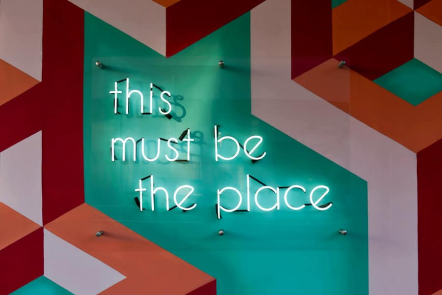 Neon sign saying "This must be the place"